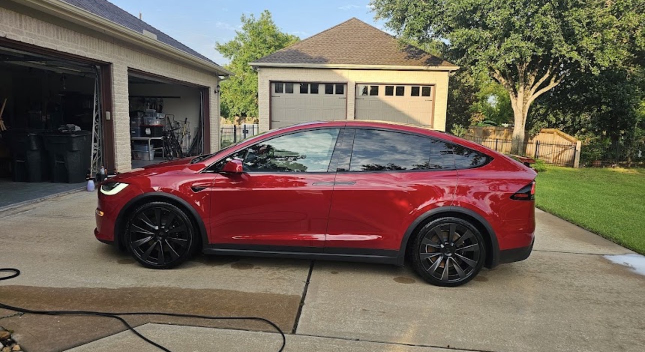 Red Tesla Model X with mirror-gloss finish